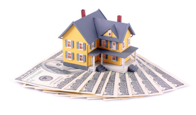 Miniature house over money isolated